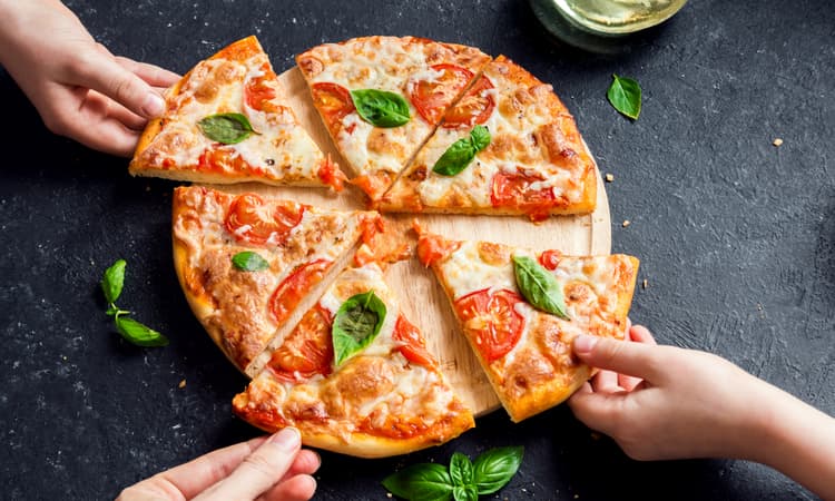 Which German-speaking Swiss city has the cheapest pizza?