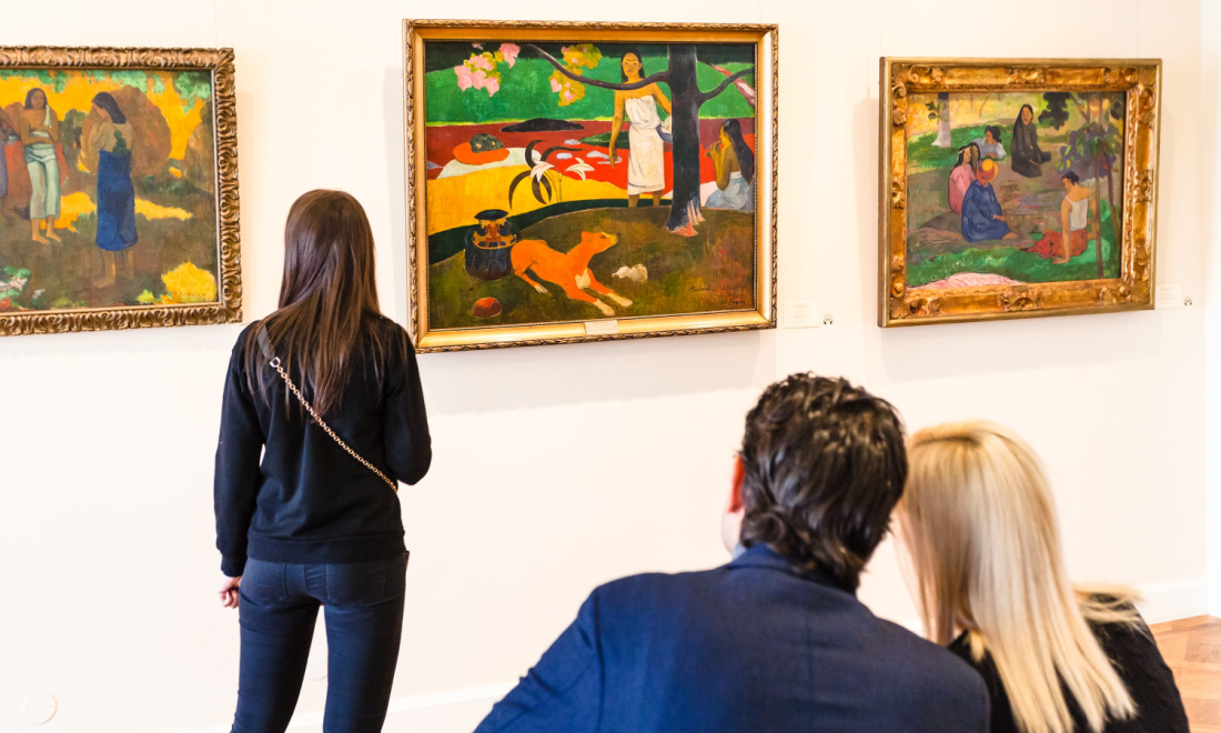 People looking at paintings in an art gallery in Munich