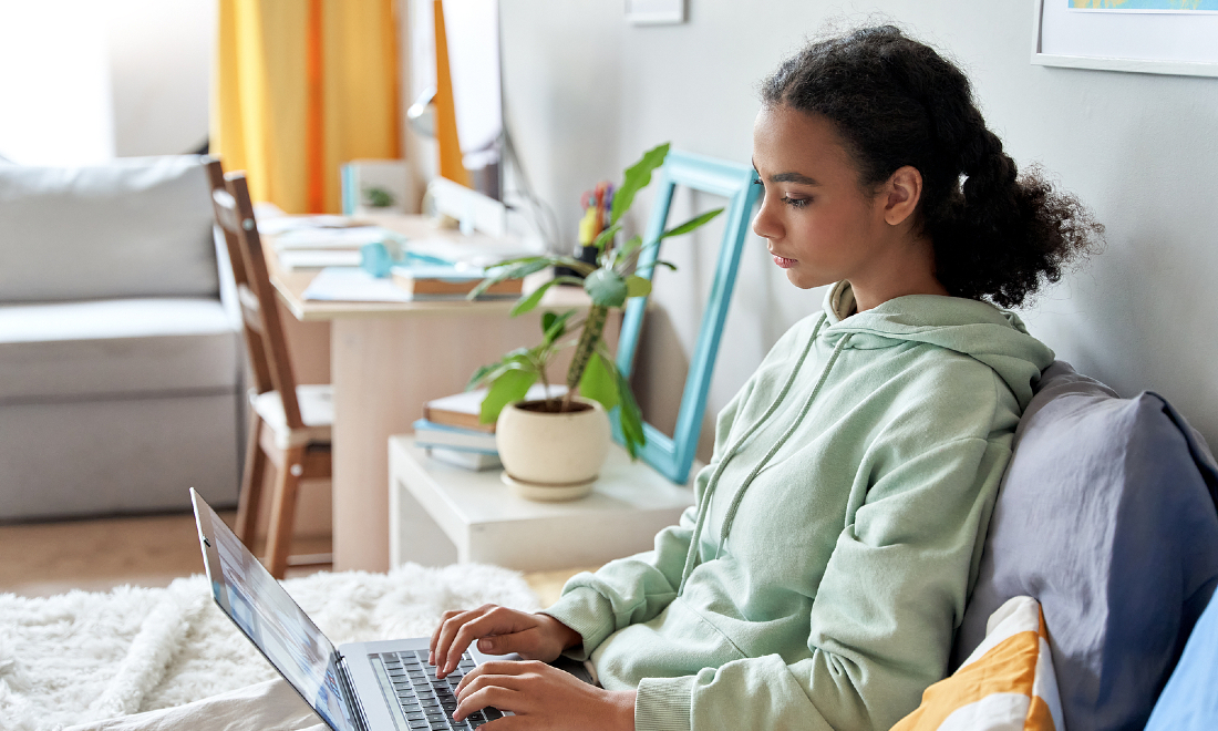 teenager using laptop at home