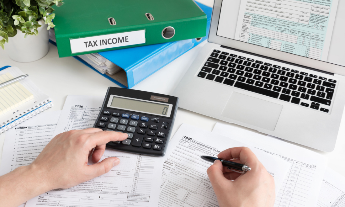 OrangeTax person filing taxes on laptop