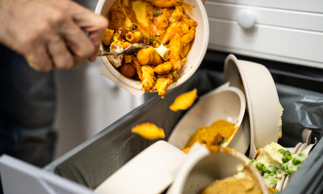 Man throwing away leftover food