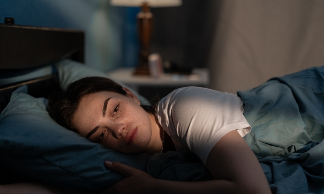 woman lying in bed alone