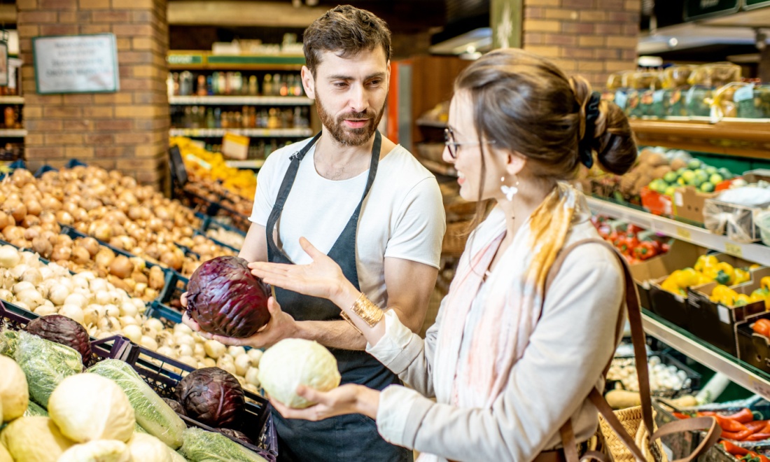 Man helping woman in grocery store