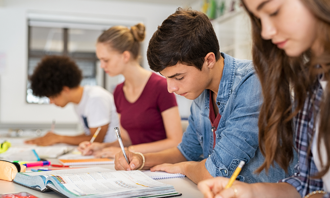 group students writing notes in class