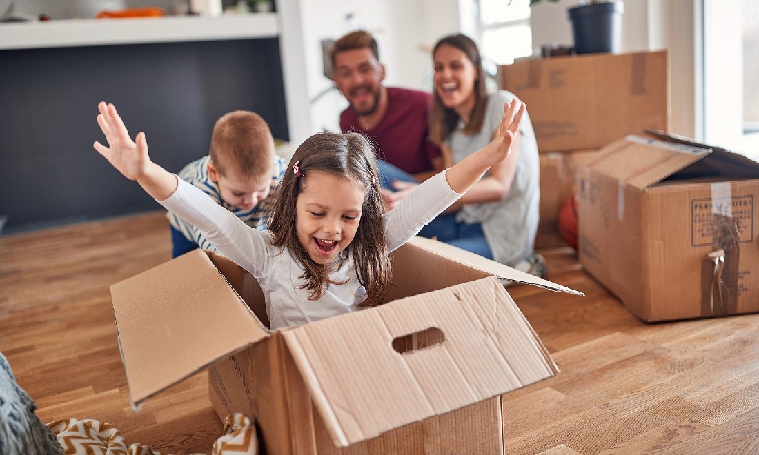 parents and kids playing with moving boxes - relocating to netherlands with kids