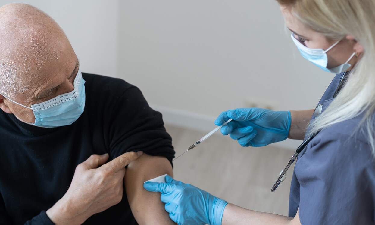 doctor injecting covid booster shot