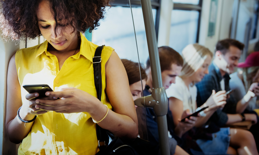 Public transport passengers looking at phones