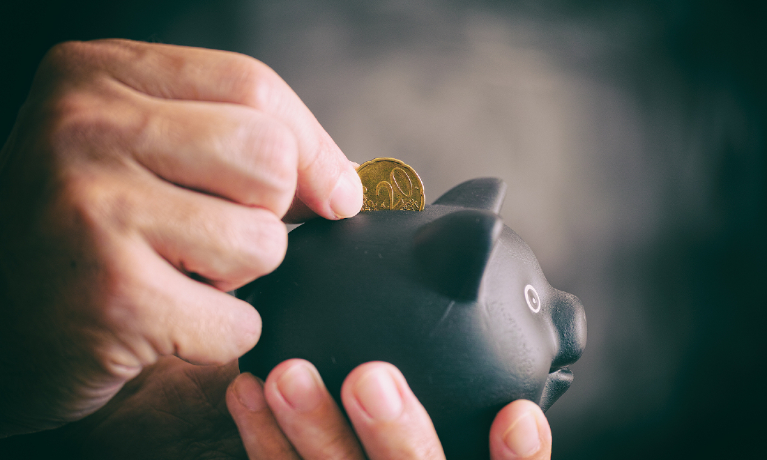 putting euro cent coin in piggy bank