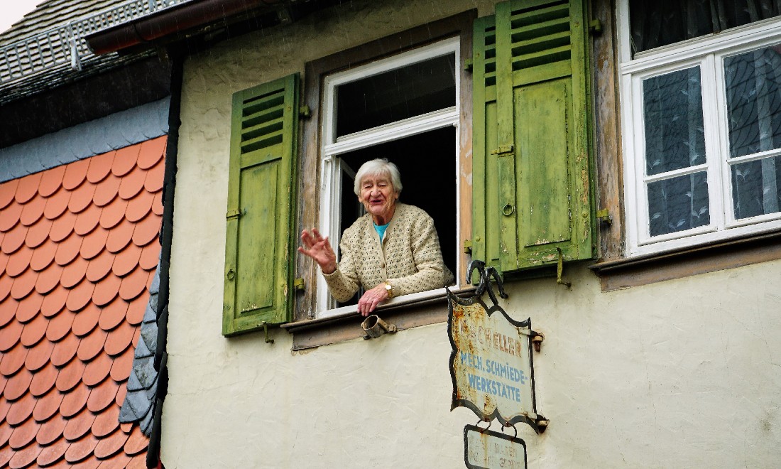 Woman waving Servus greeting in Bavaria, Germany