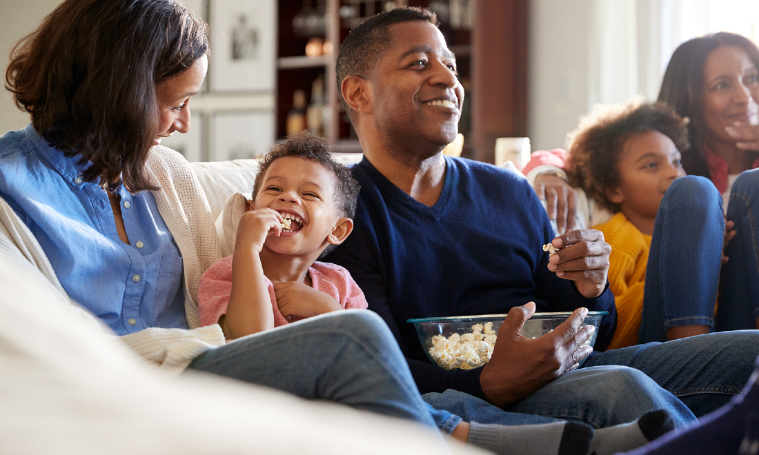 three generation family watching tv