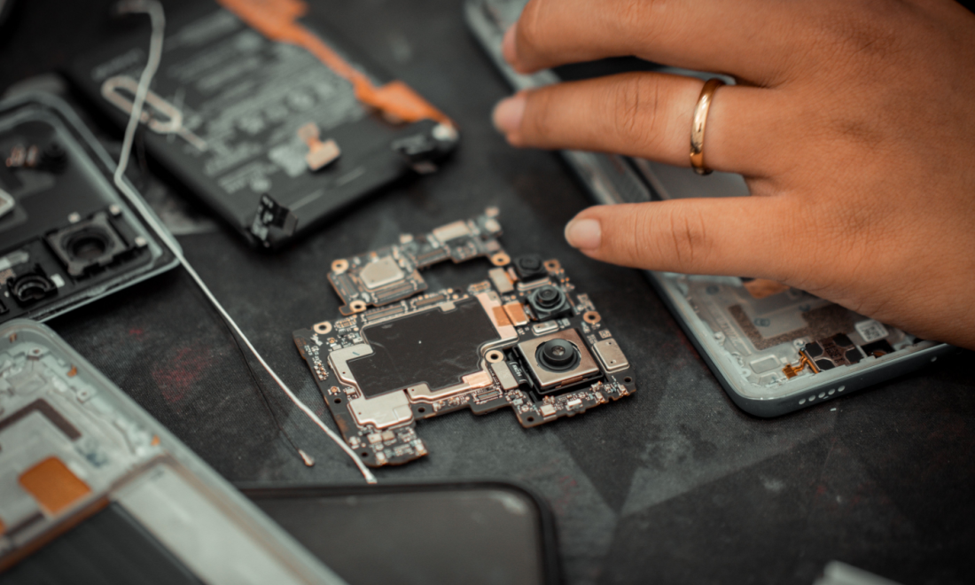A woman repairing a broken smartphone